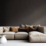light brown sofa with beige carpet in apartment on grey wall background
