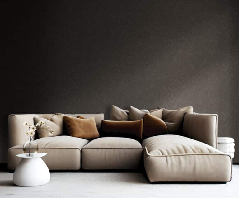 light brown sofa with beige carpet in apartment on grey wall background
