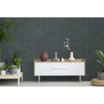Real photo of a botanic living room interior with burlap artwork on the gray wall and white cupboard surrounded by plants
